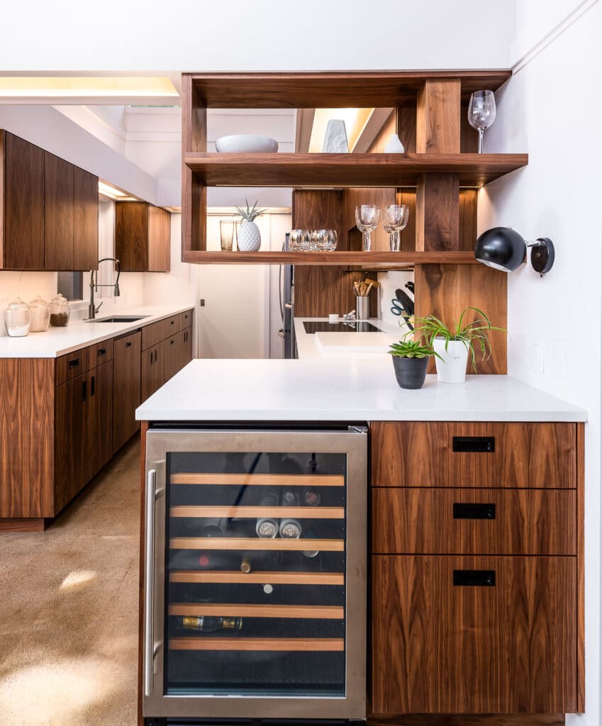 full walnut kitchen with wine fridge and black cabinet pulls