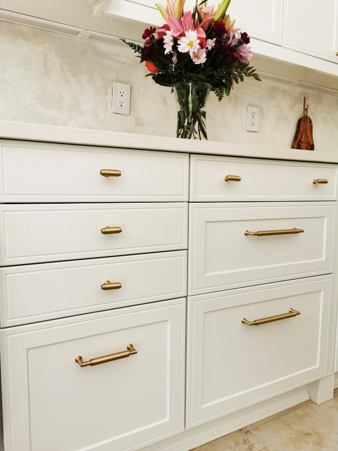 white base cabinet drawers with gold hardware